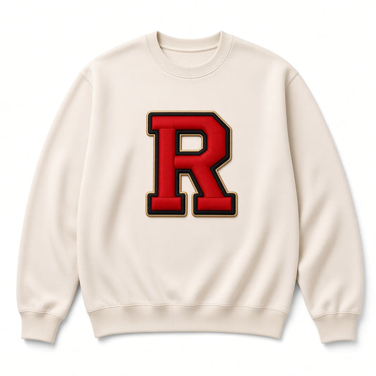 Cream REALIGION Varsity R Crewneck sweatshirt with large red varsity R patch outlined in black and gold