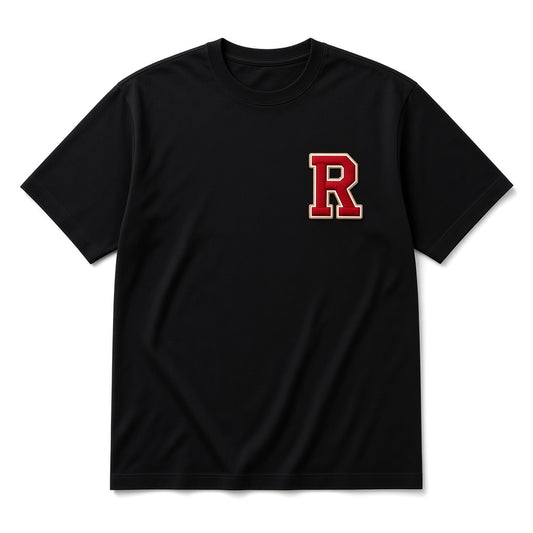 Black REALIGION Varsity R Tee with red varsity R patch outlined in cream and gold at the left chest